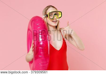 Smiling Young Woman Girl In Red One-piece Swimsuit Cap Swimming Goggles Posing Isolated On Pink Back