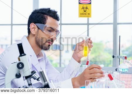 Doctor And Microbiologist With Vacuum Tubes For Samples With Covid 19 Infection Atypical Pneumonia V