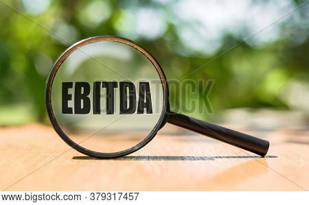 Ebitda - Earnings Before Interest, Taxes, Depreciation And Amortization - On Magnifying Glass
