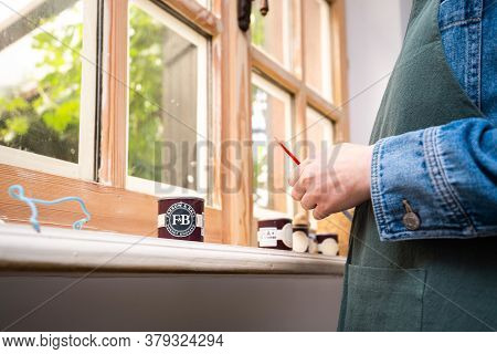 Paris, France - May 30, 2020: Wide Low Anggle View Of Woman Testing Paint Sample Pot Of Farrow And B