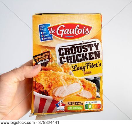 Paris, France - May 30, 2020: Pov Male Hand Holding Against White Background Package With Le Gaulois