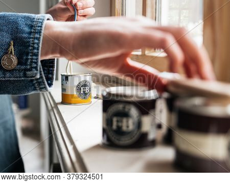 Paris, France - May 30, 2020: Close-up Side View Of Woman Testing Paint Sample Pot Of Farrow And Bal