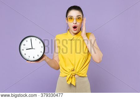 Shocked Young Brunette Woman Girl In Yellow Casual Shirt Posing Isolated On Violet Wall Background S