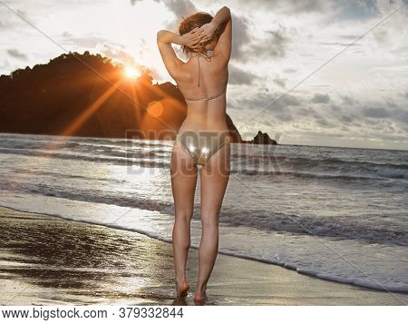 Young sexy woman in bikini on beack
