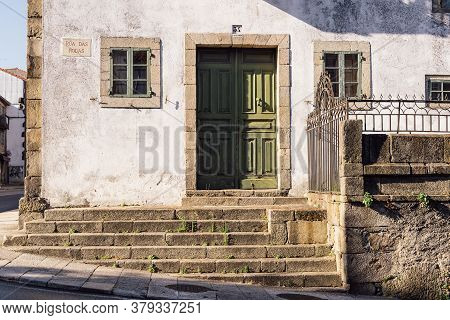 Santiago De Compostela, Spain - July 18, 2020: Old House With Green Wooden Door In Medieval Town