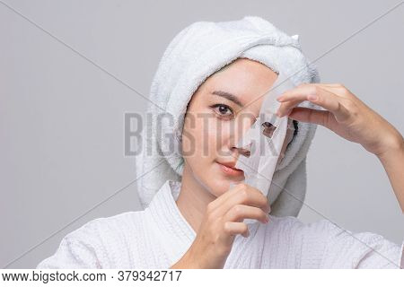 Asian Woman Pulling Away Mask From Her Face, Treatment Hyperpigmentation And Melasma On Face By Seru