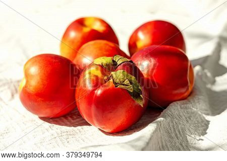 Red Ripe Organic Nectarine Fruits On The White Kitchen Towel. Summertime Healthy Eating Concept. Fru