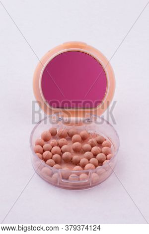 Make-up Powder Balls In A Box Isolated On White. Close Up Round Cosmetic Box With Beige Powder Spher