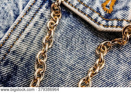 Gold Chain On A Denim Jacket. Casual Wear. Bijuteria. Jewelry. Fashionable Accessories. Close-up