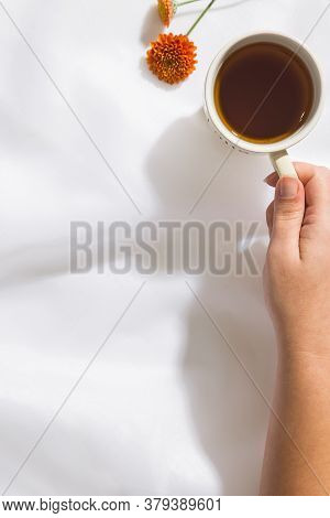 Top view of voile fabric background with flowers in two corners with space for text