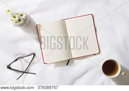 Top view of voile fabric background with flowers in two corners with space for text