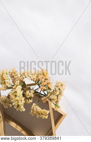 Top view of morning scene in voile fabric background with a red notebook in the middle and a vase of