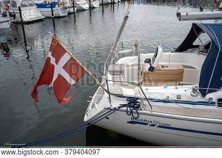Hundested, Denmark - August 2, 2020: A Danish Flag In The Back Of A Sailboat In The Marina