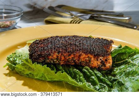 Cajun Cuisine Blackened Salmon Steak On Marble Kitchen Table