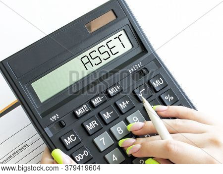 A Calculator With Text Asset On The Display