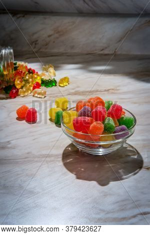Granulated Sugar Coated Candy Gumdrops With Spilled Jar Of Gummy Bears In Background
