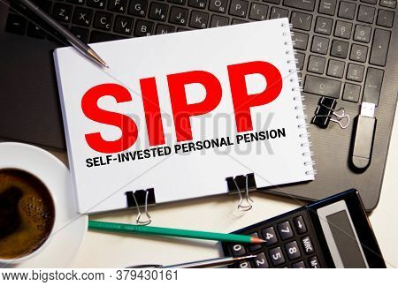 Paper With Self-invested Personal Pension Sipp On A Table With Chart, Pen And Magnifier