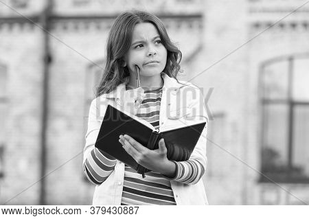 Imaginative World. Little Child Hold Book With Thoughtful Look. Nurturing Childhood Imagination. Ima