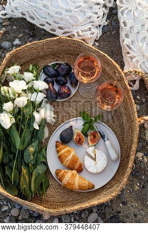 Upper View Image Of An Outdoor Picnic With Wine, Croissants, Camamber Cheese, Figs And Lisianthus Fl