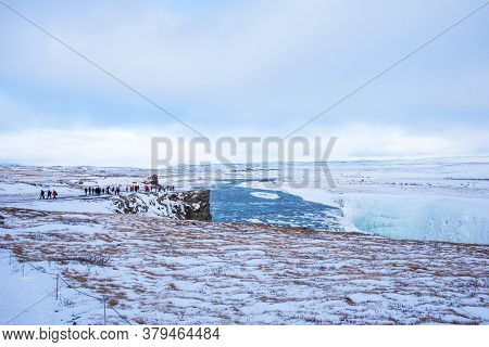 Gullfoss, Iceland - March 4, 2020: People At Viewpoint Over Gullfoss Waterfall, One Of The Most Popu