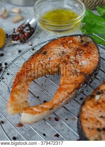 Grilled Red Fish On The Table With Oil Garlic