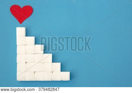 Ladder Of Sugar Cubes Laid Out, A Red Heart At The Top Of The Stairs On A Blue Background, Copy Spac