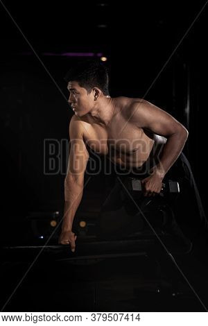 Handsome Man Raising Dumbbell,doing Exercise For Buit Muscle,fit And Firm Body,model Posing