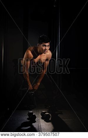 Handsome Man Raising Dumbbell,doing Exercise For Buit Muscle,fit And Firm Body,model Posing