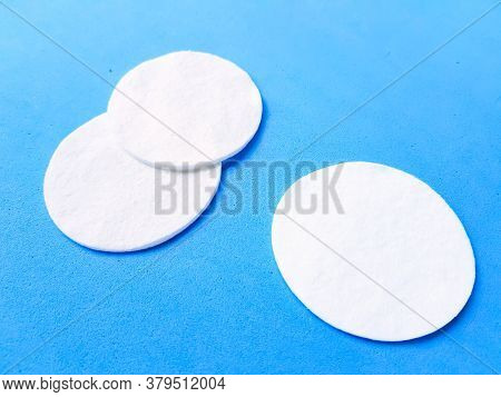 Cotton Cotton Cotton Discs On A Blue Background. Cosmetology And Medicine. Taking Care Of Yourself.