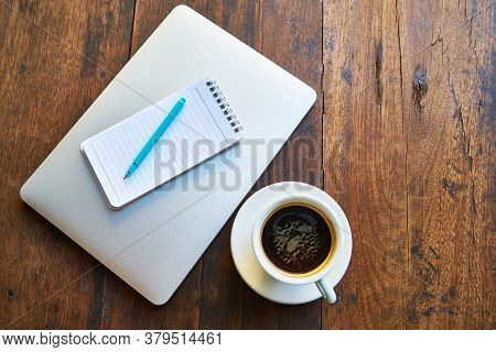 Hot Healthy And Tasty Coffie Drink On The Cup With Notebook