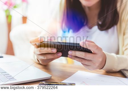 Asian Woman Playing Online Game Application Or Chatting Text Message With Friend By Using Smart Phon