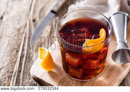 Boulevardier Cocktail And Orange Zest On Wooden Table. Copy Space
