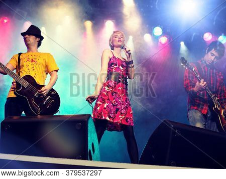 Young female rockstar Singing in Concert