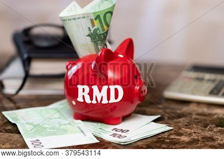 Rmd Require Minimal Distribution On The Heading. The Inscription On A Piggy Bank Standing On A Bundl