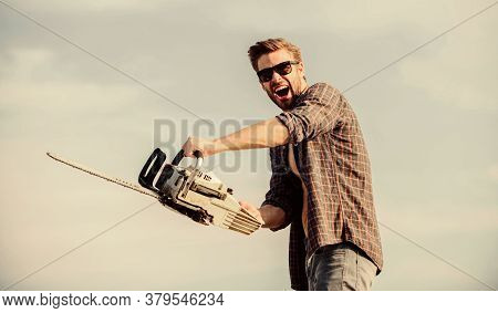 Sharp Blade. Dangerous Job. Feeling Manly. Powerful Chainsaw. Handsome Man With Chainsaw Blue Sky Ba