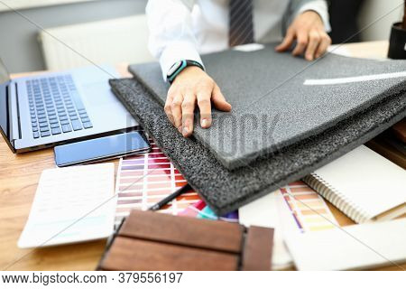 Male Hands Hold Flooring Samples For Repairing A Room. Selection Of Colored Laminate And Ceramic Til