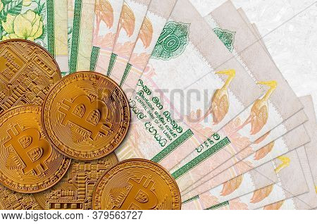 10 Sri Lankan Rupees Bills And Golden Bitcoins. Cryptocurrency Investment Concept. Crypto Mining Or 