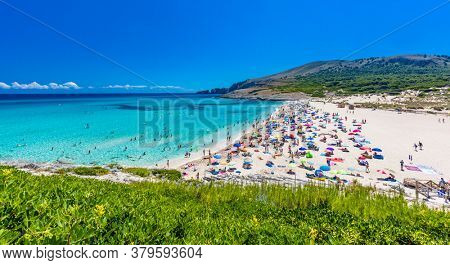 CALA MESQUIDA, MALLORCA, SPAIN - 19 July 2020: People enjoying beautiful sandy beach of on Mallorca, Mediterranean Sea, Balearic islands, Spain.