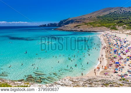 CALA MESQUIDA, MALLORCA, SPAIN - 19 July 2020: People enjoying beautiful sandy beach of on Mallorca, Mediterranean Sea, Balearic islands, Spain.