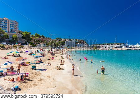 PORT ADRIANO, MALLORCA, SPAIN - 23 July 2020 - Tourists enjoying summer day on the popular city beach.