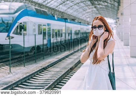 A Girl In A Medical Mask At The Railway Station.