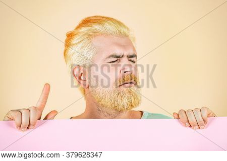 Man Holding Empty Blank Board. Caucasian Blond Male Model Posing In Fashion Concept Studio Shoot. Bl