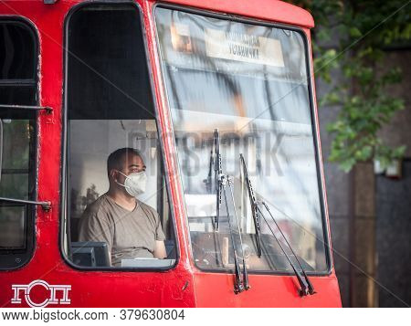 Belgrade, Serbia - July 8 2020:  Tram Drivier, A Man, Working In His Cabin Wearing A Respiratory Fac