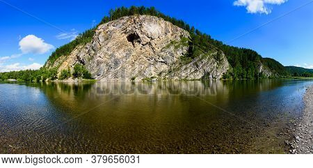 Beautiful Landscape Of The Calm River With Coastal Cliffs And Coniferous Forest, Reflected In The Wa