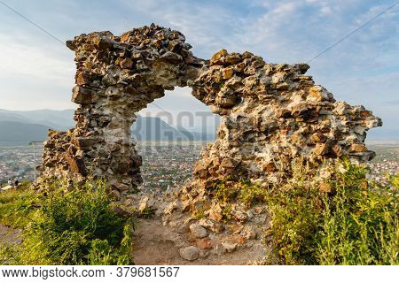Ruins Of Old Hungarian Castle At Sunset  In Khust City, Western Ukraine.
