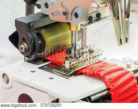 Close Up Of Sewing Process On The Overlock In The Sewing Shop. Tailoring Industry.. Interior Of Garm
