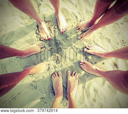 Ten Feet Of A Family Of Five On The Sandy Beach In Summer With Old Toned Effect