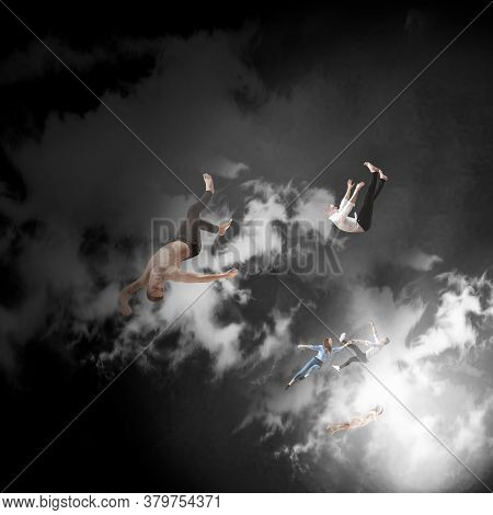 Mid-air Beauty Cought In Clouds. Full Length Shot Of Attractive Young Woman And Man Hovering In Air 