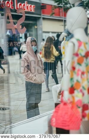 Manchester, England, Uk - 24 July, 2020 City Centre Of Manchester, Young Girl In Face Mask Is Lookin