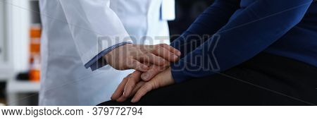 Woman Sitting On Clinic, Doctor Reassuring Patient. Doctor Helps Elderly Woman To Resist During Illn